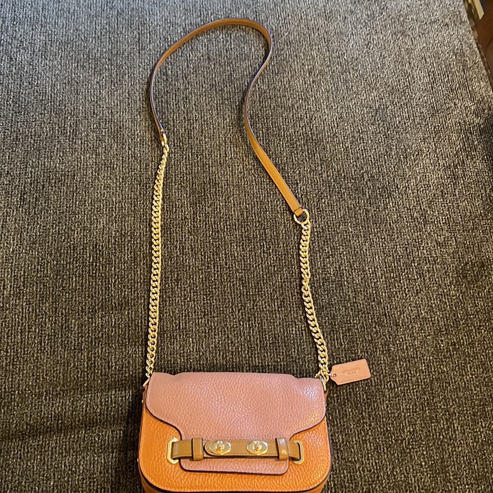 Coach crossbody gently used, small scratch in listing on front flap of purse